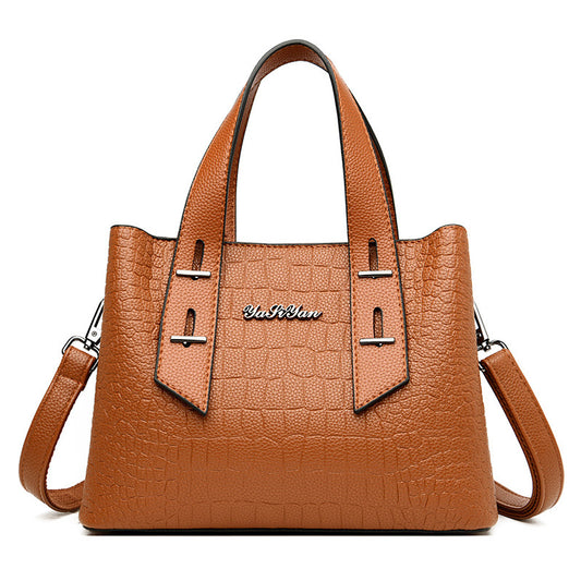 Brown handbag with a visible brand logo on a white background