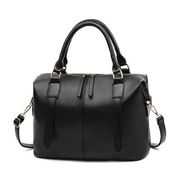 Black handbag with gold accents on a white background